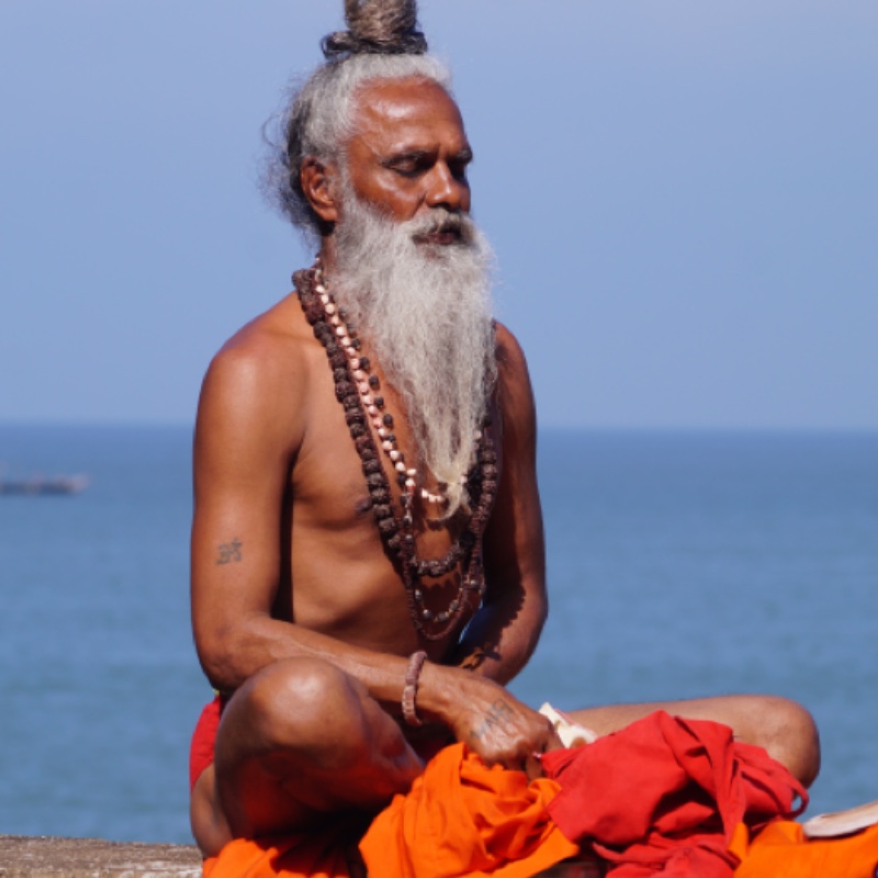 guru meditating by the sea